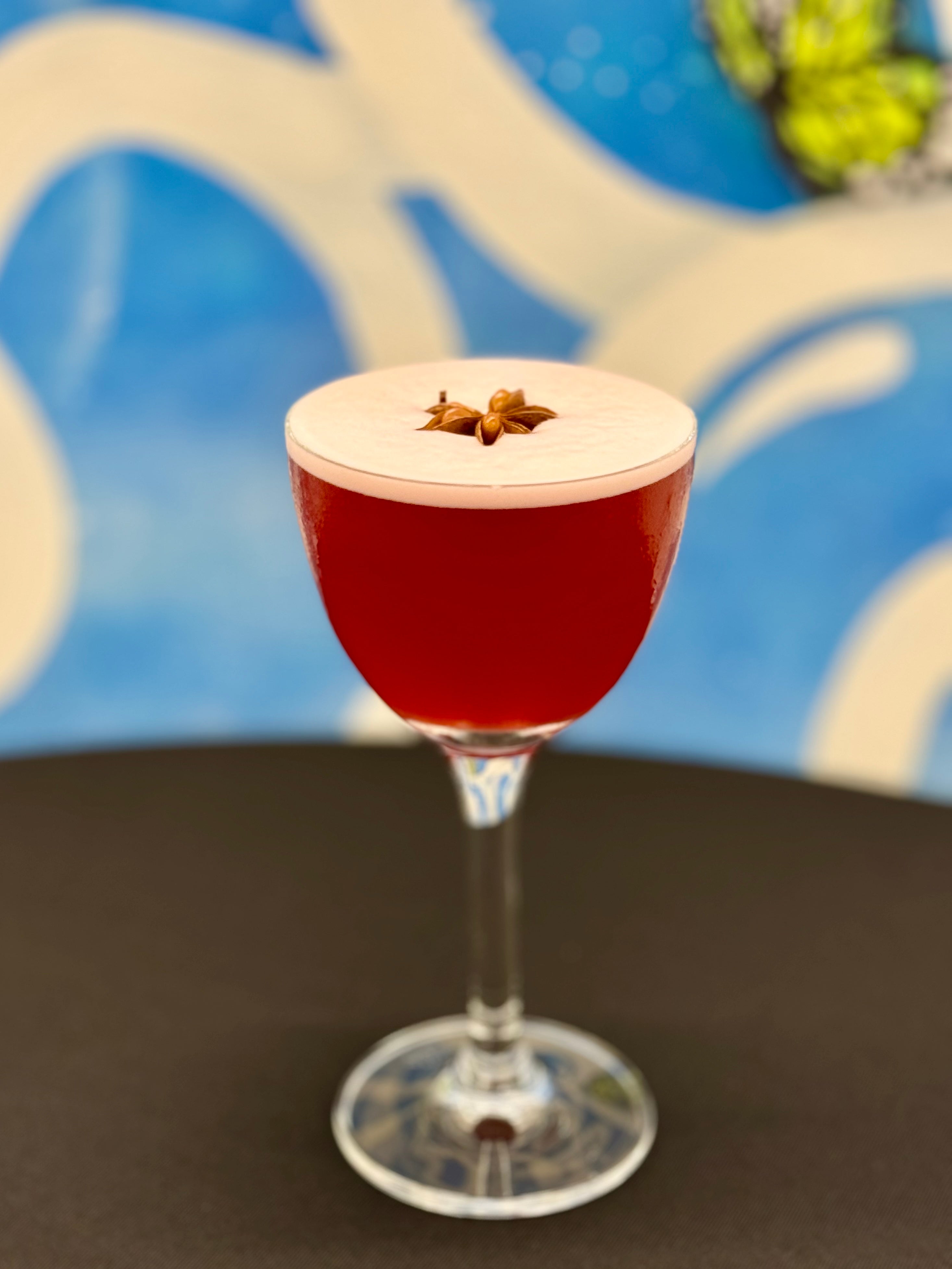 Red cocktail on table with black tablecloth