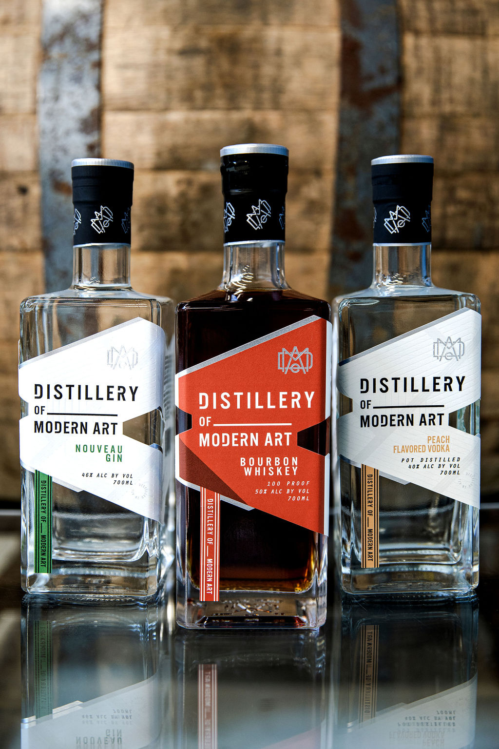 DoMA at 250 Bourbon bottles beside a barrel