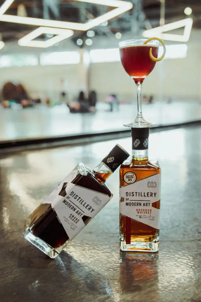 https://distilleryofmodernart.com/wp-content/uploads/2025/04/DoMA-bottles-practicing-yoga-w-Fly-640x960.jpg